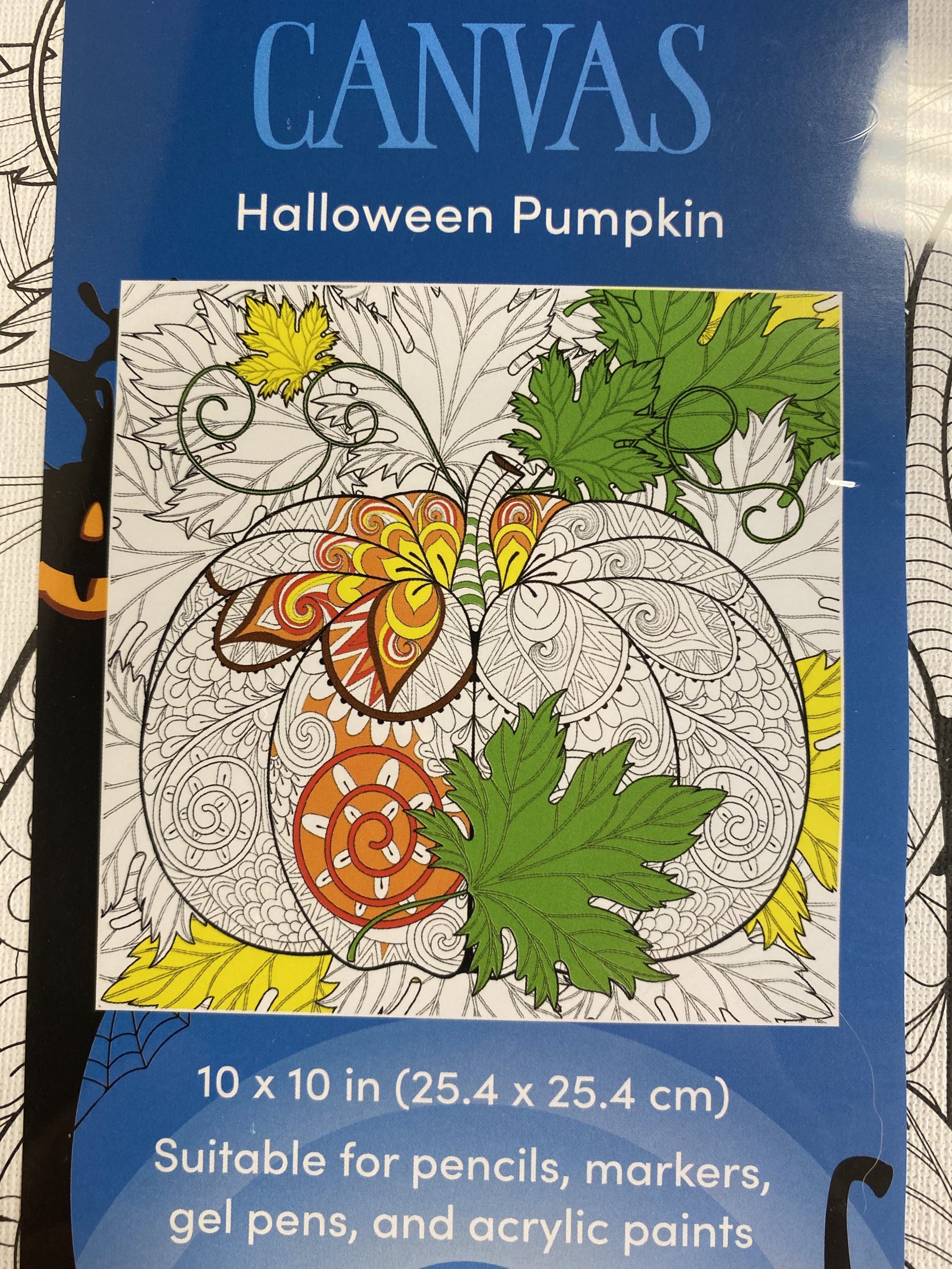 IMG_8008 photo of arts and crafts project kit, Canvas Halloween Pumpkin 10 x 10 in (25.4 x 25,4 xm) Suitable for pencils, markers, gel pens, and acrylic paints Image of pumpkin with color-in lines partially completed with green and yellow leaves, orange and mostly uncompleted