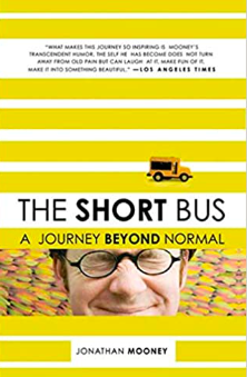 Short Bus Book Book cover for The Short Bus a Journey Beyond Normal showing the author Jonathan Mooney squinting his eyes while wearing glasses in front of a pastel abstract design. Also featured on the cover is a short school bus and the words "What makes this journey so inspiring is Mooney's transcendent humor. The self he has become does not turn away from old pain but can laugh at it, make fun of it, make it into something beautiful."-Los Angeles Times. Also featured are mustard yellow and white hortizontal stripes.